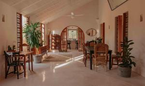 a living room with tables and chairs and a dining room at Galopina in Seyé