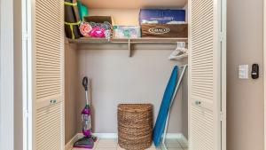 a closet with wooden doors and a baseball bat at Beach Cozy North Shore Turtle Bay Condo in Kahuku +15 photos