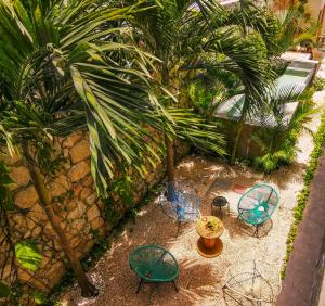 an overhead view of chairs and tables in a garden at Les Suites Calle 2 by Galian in Tulum +61 photos