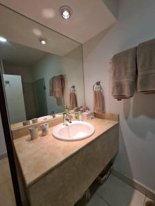 a bathroom with a sink and a large mirror at Villamagna Nuevo Vallarta in Nuevo Vallarta
