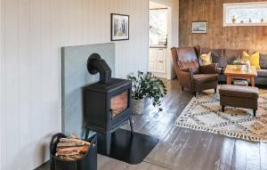 a living room with a wood stove in it at 3 Bedroom Awesome Home In Finns in Kuleseid