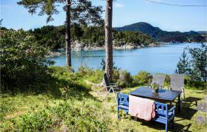 a table and chairs with a view of a lake at Gorgeous Home In Reksteren With Kitchen in Klinkholmen