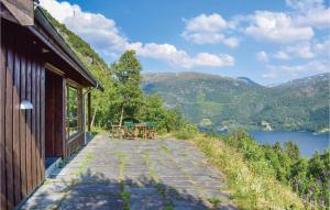 a patio with tables and chairs on the side of a house at Nice Home In Rldal With 4 Bedrooms in Røldal