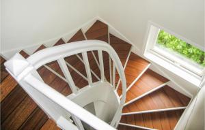a white spiral staircase with a window at 4 Bedroom Stunning Home In Rong in Rong