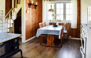 a kitchen with a table with a table cloth on it at One-Bedroom Holiday Home In Austmarka in Östmarken