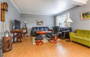 a living room with a leather couch and chairs at Nice Home In Gjra With 2 Bedrooms And Wifi in Musgjerd