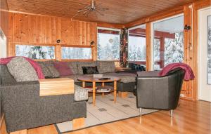 a living room with a couch and a table at Pet Friendly Home In Trysil With Sauna in Trysil