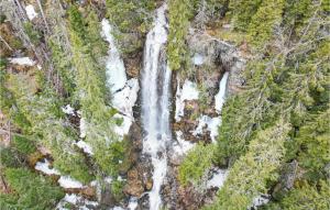 an aerial view of a waterfall in a forest at Alpinhytte 2 in Favang +7 photos