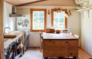 a kitchen with a large wooden island in the middle at Nice Home In Sjusjøen With Wifi in Sjusjøen