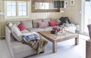 a living room with a couch and a table at 3 Bedroom Stunning Home In Uvdal in Dagali