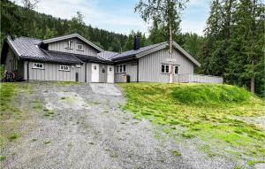 a house on a hill with a dirt road in front at 3 Bedroom Beautiful Apartment In Hemsedal in Hemsedal