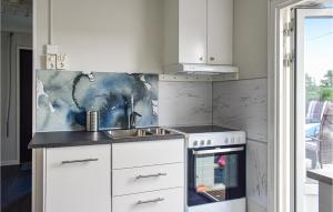 a kitchen with a sink and a stove at Gorgeous Home In Billesholm With Kitchen in Billesholm