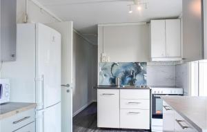 a white kitchen with white cabinets and a sink at Gorgeous Home In Billesholm With Kitchen in Billesholm