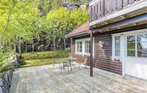 a patio with a table and chairs on a house at Gorgeous Home In Lindesnes With Kitchen in Svenevik