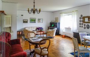 a living room with a couch and chairs and a table at 4 Bedroom Gorgeous Home In Degerhamn in Degerhamn