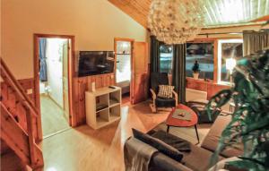 a living room with a couch and a tv at Gorgeous Home In Sysslebäck With Sauna in Branäs