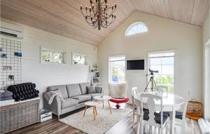 a living room with a couch and a table at Beautiful Home In Lidkping With House Sea View in Lidköping