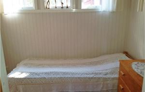 a small bed in a room with a window at 3 Bedroom Awesome Home In Srna in Särna