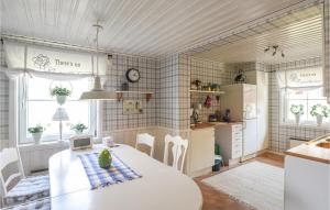 a kitchen and dining room with a table and chairs at Beautiful Home In Undenäs in Undenäs