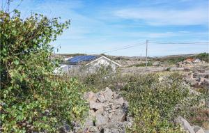 a house sitting on top of a hill with bushes at 1 Bedroom Nice Home In Bohus-Malmön in Bohus-Malmön +7 photos