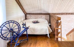 a bedroom with a bed with aokedoked wheel in a attic at Stunning Home In Svanesund With Wifi in Svanesund