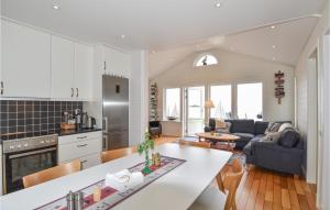 a kitchen and living room with a couch and a table at Stunning Home In Mellerud in Mellerud