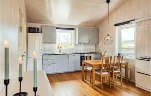 een keuken met een houten tafel en een houten vloer bij Lovely Home In sensbruk With Kitchen in Åsensbruk