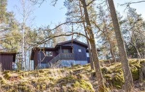 a house on a hill in the woods at Nice Home In Skrblacka With Kitchen in Skärblacka