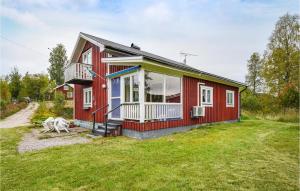 a red house with a large yard at 2 Bedroom Pet Friendly Home In Ekshärad in Ekshärad