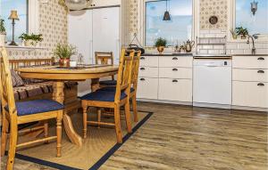 a kitchen with a wooden table and chairs at Lovely Home In Hofors With Kitchen in Hofors