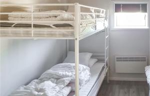 a bedroom with two bunk beds and a window at Cozy Home In Sysslebck With Kitchen in Sysslebäck