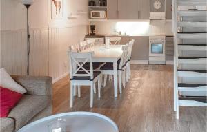 a kitchen and dining room with a white table and chairs at Cozy Home In Sysslebck With Kitchen in Sysslebäck
