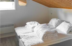 a bed with white sheets on it in a room at Cozy Home In Sysslebck With Kitchen in Sysslebäck