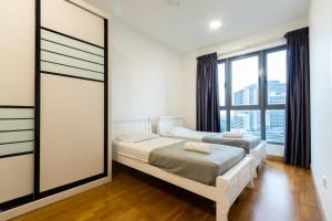 Postel nebo postele na pokoji v ubytování Teega Suites by RR JBcity
