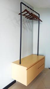 a display case with a wooden shelf and black metal supports at Rio City Hotel in Palembang