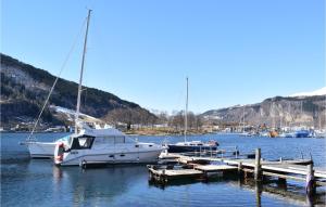 a group of boats docked at a dock in the water at Nice Home In Norheimsund With Wifi And 3 Bedrooms in Norheimsund