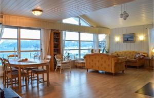 a living room with a table and a couch at Pet Friendly Home In Lavik With House Sea View in Lavik