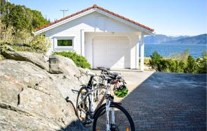 a group of bikes parked in front of a garage at 5 Bedroom Beach Front Home In Lavik in Lavik