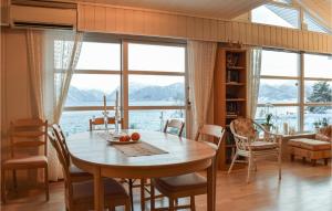 a dining room with a table and a view of the water at 5 Bedroom Beach Front Home In Lavik in Lavik