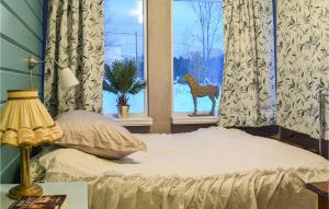 a bedroom with a bed with a deer in a window at Awesome Home In Eikefjord With 3 Bedrooms And Wifi in Eikefjord