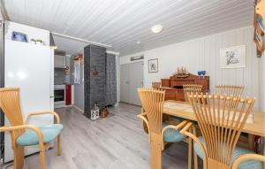 a dining room with a wooden table and chairs at Beautiful Home In Isfjorden With 2 Bedrooms And Wifi in Isfjorden
