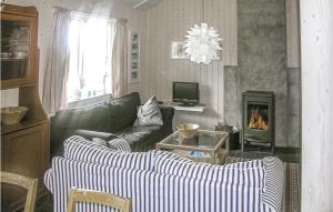 a living room with two couches and a fireplace at Beautiful Home In Gl With 3 Bedrooms, Sauna And Wifi in Gålå
