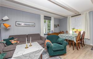 a living room with a couch and a table at Nice Apartment In farnes With House Sea View in Åfarnes