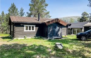 a small cabin with a car parked in front of it at Nice Home In Kvam With Kitchen in Kvam