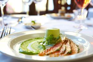 a white plate with some food on a table at The Wrea Head Hall Country House Hotel & Restaurant in Scarborough