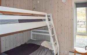a bunk bed room with two bunk beds and a window at Awesome Home In yer With House A Mountain View in Øyer