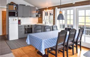 a kitchen and dining room with a table and chairs at Awesome Home In yer With 3 Bedrooms And Wifi in Øyer