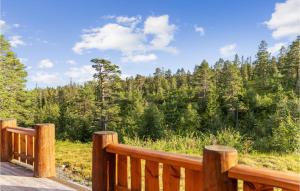 a wooden deck with a view of a forest at Gorgeous Home In Lampeland With Kitchen in Lampeland
