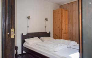 a bedroom with a bed and a wooden door at Staven Appartments in Hemsedal