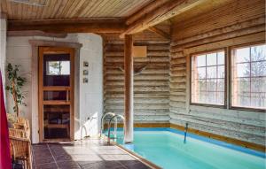 a swimming pool in a wooden house with a swimming pool at Gorgeous Home In Vegårshei With Wifi in Vegårshei +25 photos